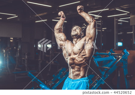 Handsome model muscle man abs workout in gym 44520652