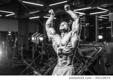 Handsome model muscle man abs workout in gym 44520653
