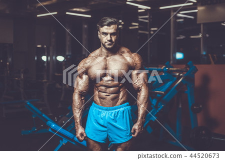 Handsome model muscle man abs workout in gym Handsome model muscle man abs workout in gym 44520673