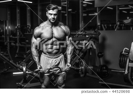 Handsome model muscle man abs workout in gym 44520698
