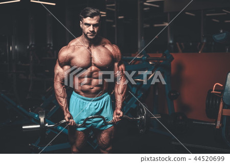 Handsome model muscle man abs workout in gym 44520699