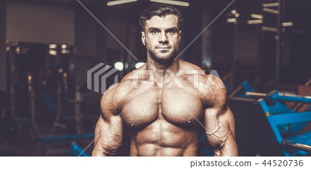 Handsome model muscle man abs workout in gym Handsome model muscle man abs workout in gym 44520736