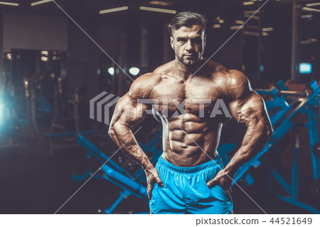 Handsome model muscle man abs workout in gym 44521649