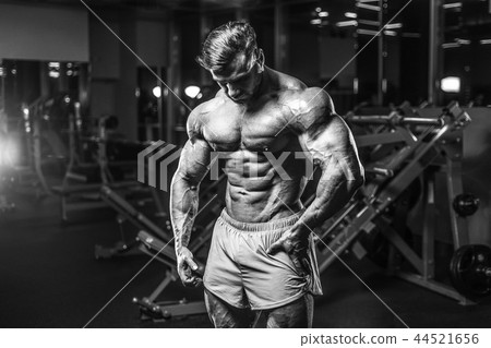 Handsome model muscle man abs workout in gym 44521656