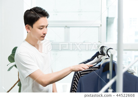 Men choosing clothes Men choosing clothes 44522608