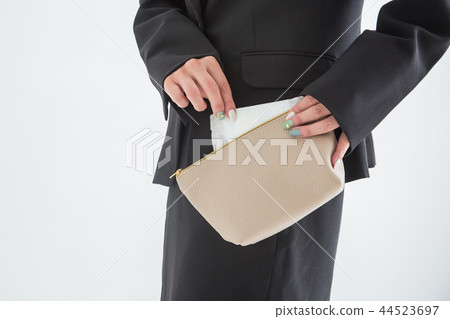 Woman taking the napkin out of the pouch 44523697