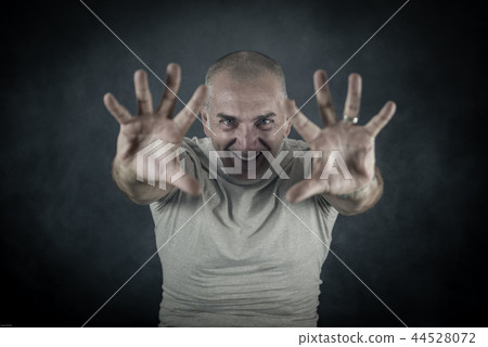 Man Showing Palms Like Casting a Spell 44528072