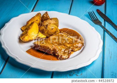 Grilled pork steak and fried potatoes 44528972