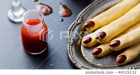 Cookies Witch's fingers and bloody cocktail for Halloween party celebration. Close up. Cookies Witch's fingers and bloody cocktail for Halloween party celebration. Close up. 44529132