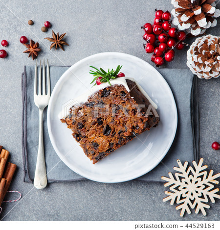 Christmas fruit cake, pudding on white plate. Copy space. Top view. Christmas fruit cake, pudding on white plate. Copy space. Top view. 44529163
