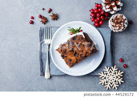 Christmas fruit cake, pudding on white plate. Copy space. Top view. Christmas fruit cake, pudding on white plate. Copy space. Top view. 44529172