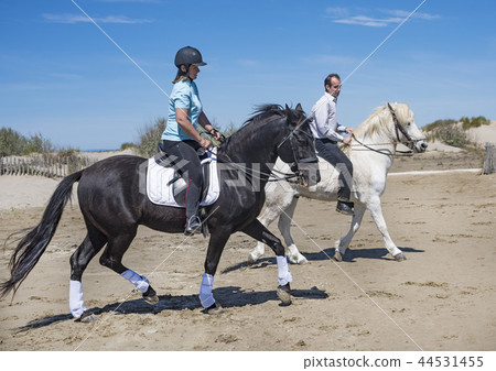 riding couple on the beach 44531455