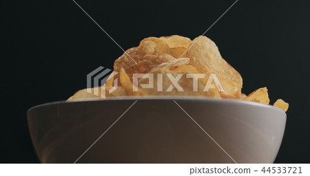 closeup potato chips in white bowl low angle shot 44533721