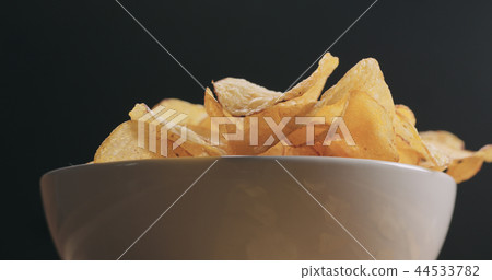 closeup potato chips in white bowl low angle shot 44533782