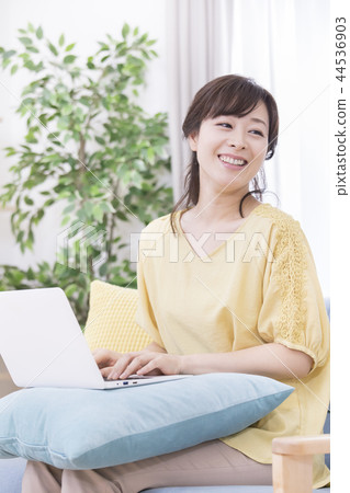 Woman operating a personal computer Woman operating a personal computer 44536903
