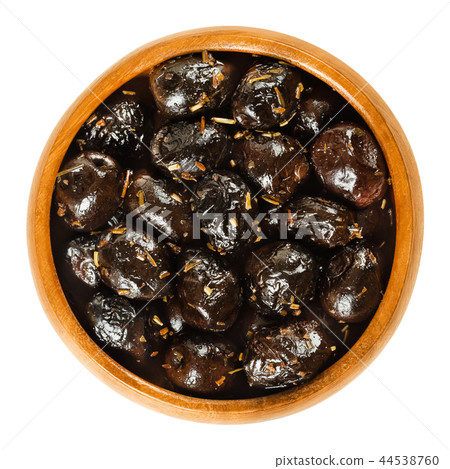 French black olives with herbs in wooden bowl 44538760