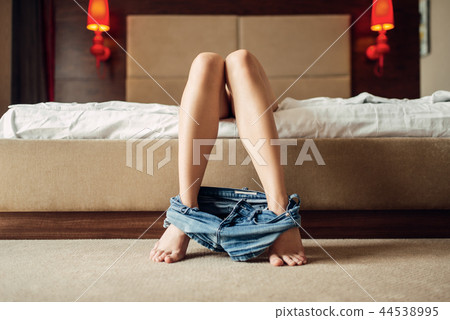 Nude woman with denim shorts down lying in bed 44538995