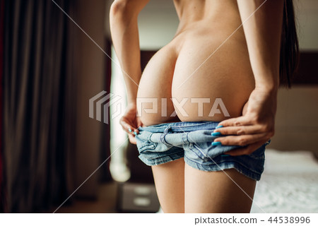 Sexy nude woman with lowered denim shorts 44538996