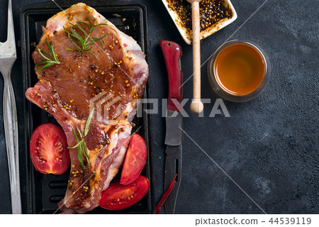 Marinating raw lamb chops with spices, honey and tomato on grill pan, close up Marinating raw lamb chops with spices, honey and tomato on grill pan, close up 44539119