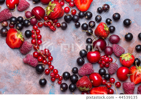 Heart shape assorted berry fruits on stone background. Flat lay 44539135