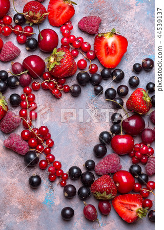 Heart shape assorted berry fruits on stone background. Flat lay 44539137