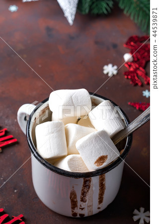 Winter hot drink close up. Hot chocolate or cocoa with marshmallow and spices on dark stone Winter hot drink close up. Hot chocolate or cocoa with marshmallow and spices on dark stone 44539871