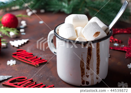 Winter hot drink close up. Hot chocolate or cocoa with marshmallow and spices on dark stone Winter hot drink close up. Hot chocolate or cocoa with marshmallow and spices on dark stone 44539872