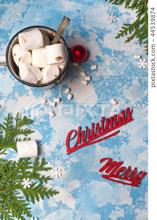 Christmas winter still life : a cup of cocoa with marshmallows sprinkled with nuts , fir cones on a Christmas winter still life : a cup of cocoa with marshmallows sprinkled with nuts , fir cones on a 44539874