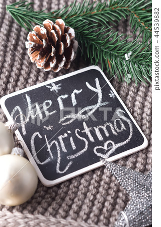 Christmas wishes written in chalk on a blackboard- Happy Christmas on warm scarf and toys Christmas wishes written in chalk on a blackboard- Happy Christmas on warm scarf and toys 44539882