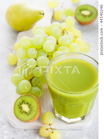 Glass of fresh smoothie organic green toned fruit  44540246