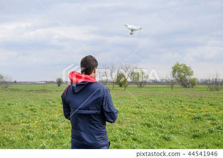 A man with a remote control in his hands. Flight control of the drone. Phantom 44541946