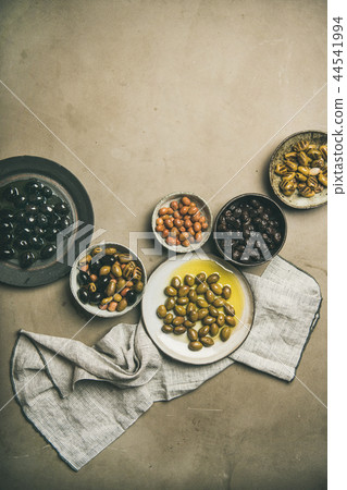 Various kinds of Mediterranean pickled olives in plates, copy space Various kinds of Mediterranean pickled olives in plates, copy space 44541994