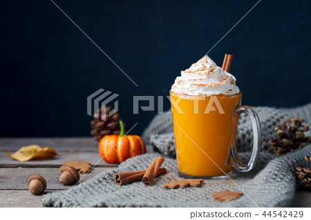 Pumpkin latte with spices. Boozy cocktail with whipped cream. Wooden background. Copy space. Pumpkin latte with spices. Boozy cocktail with whipped cream. Wooden background. Copy space. 44542429