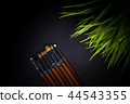 Dark background with make-up brushes 44543355