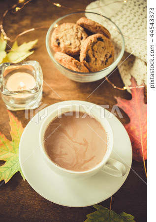 Cup of hot cocoa, nuts, cookies, candle and plaid Cup of hot cocoa, nuts, cookies, candle and plaid 44543373