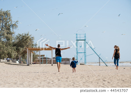 Happy family on the beach from back 44543707