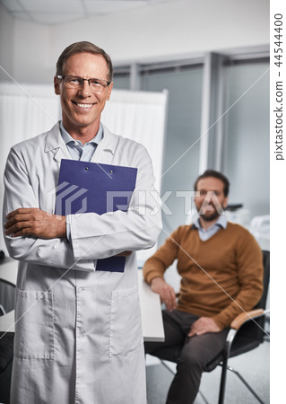 Adult doctor is holding folders in his hands 44544400