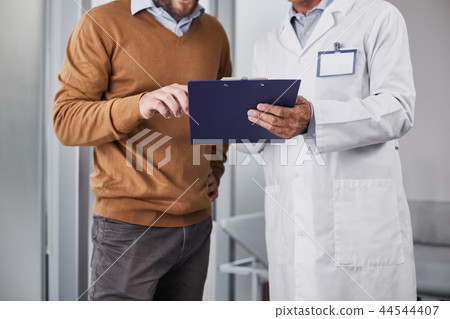 Unhealthy man is watching results of the examination Unhealthy man is watching results of the examination 44544407