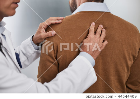 Doctor is examining spine of his patient Doctor is examining spine of his patient 44544409