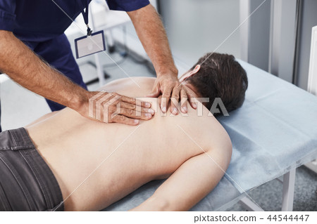 Doctor making special therapeutic procedures to patient Doctor making special therapeutic procedures to patient 44544447