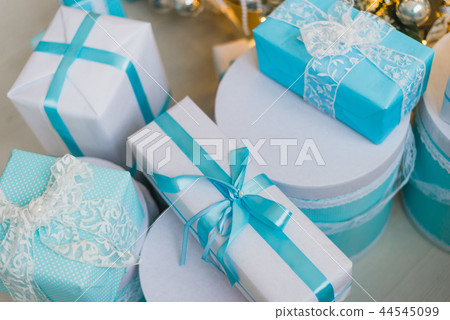Christmas gifts under the decorated tree in blue Christmas gifts under the decorated tree in blue 44545099