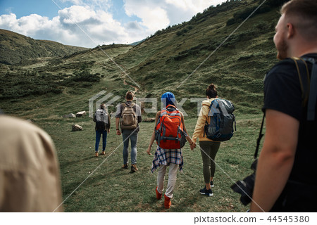 Brave tourists are wandering through mountainous landscapes Brave tourists are wandering through mountainous landscapes 44545380