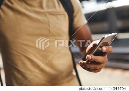 Close up of a mobile phone in hands of a man 44545704