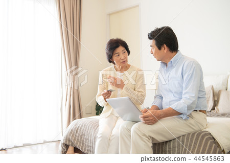 Senior couple personal computer bedroom lifestyle image Senior couple personal computer bedroom lifestyle image 44545863