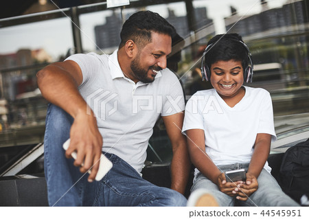 Joyful little boy resting with his Hindu father Joyful little boy resting with his Hindu father 44545951