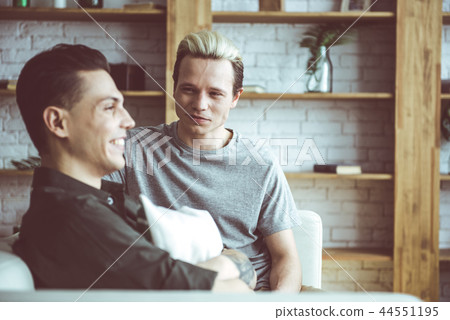 Young blond man looking at his cheerful boyfriend Young blond man looking at his cheerful boyfriend 44551195