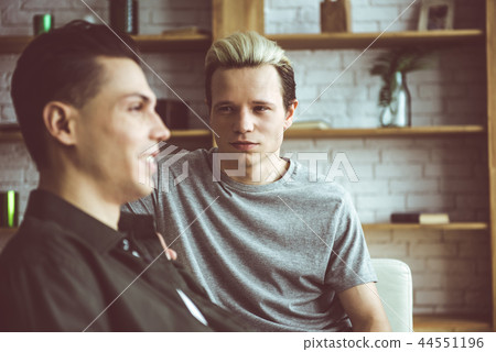 Young man with dyed hair looking at his cheerful boyfriend Young man with dyed hair looking at his cheerful boyfriend 44551196