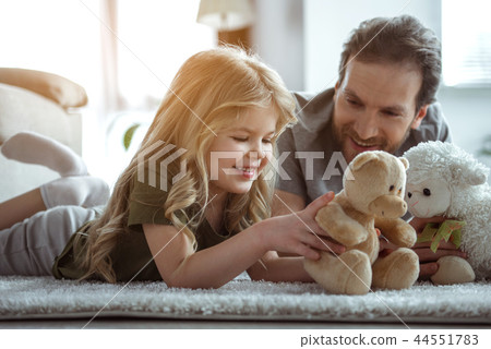 Happy family entertaining with toys together in home 44551783