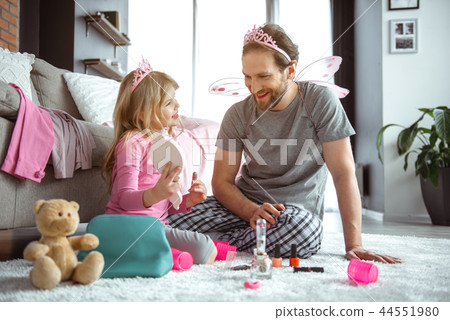 Excited father and daughter playing with cosmetics together Excited father and daughter playing with cosmetics together 44551980