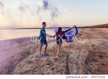 young couple running with hand flare or fusee young couple running with hand flare or fusee 44555502